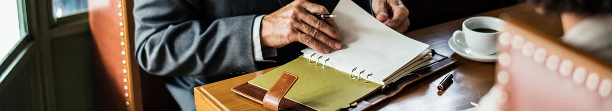A legal professional reviewing paperwork during a client meeting